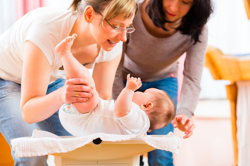 Midwife Measuring Weight Or Newborn Baby